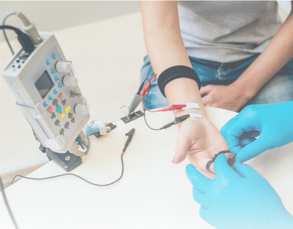 Électrodes posées sur le poignet d'une patiente pendant un EMG